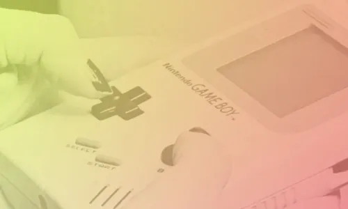 Close up of a person's hands playing a Game Boy