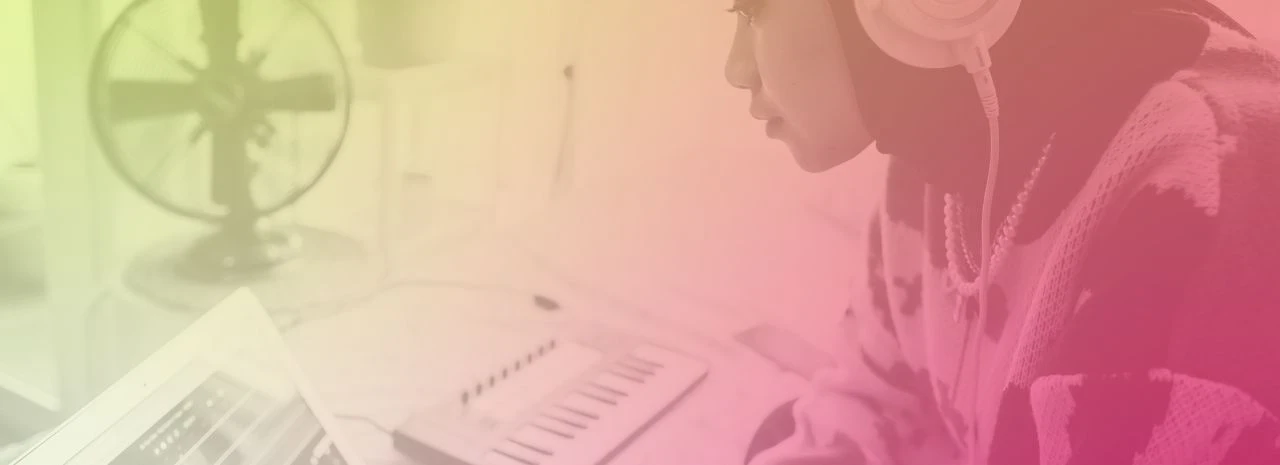 Image of a person using a laptop and keyboard