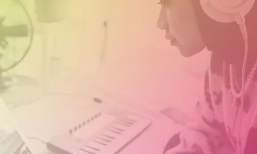 Image of a person using a laptop and keyboard