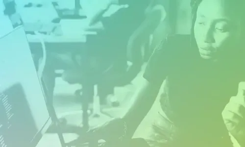 Two people looking a computer screen in an office